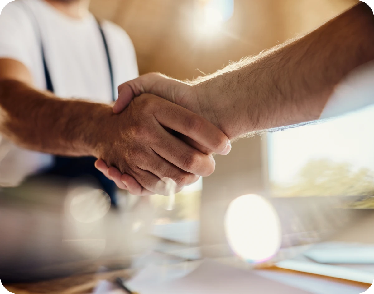 Two people shaking hands in agreement.
