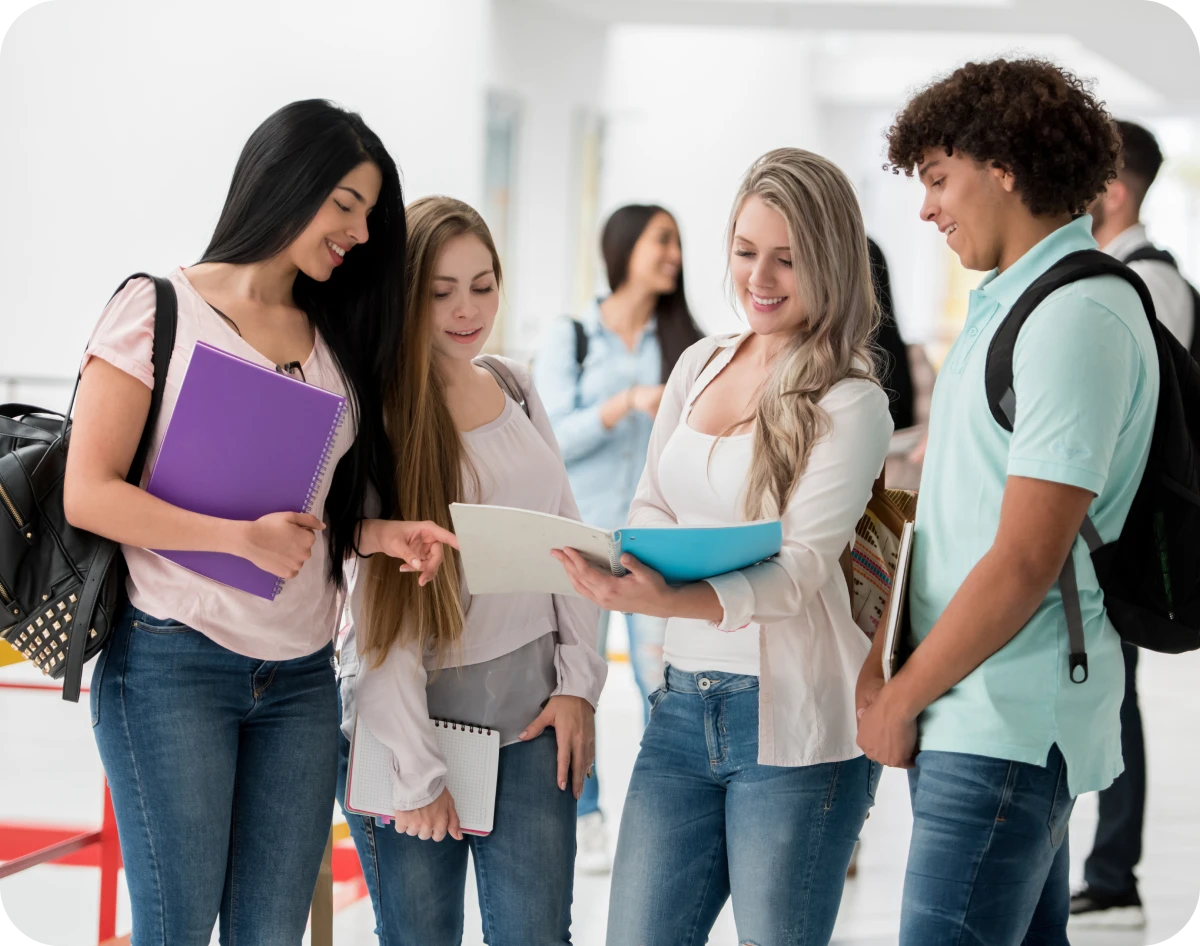 Students discussing and smiling in a hallway.